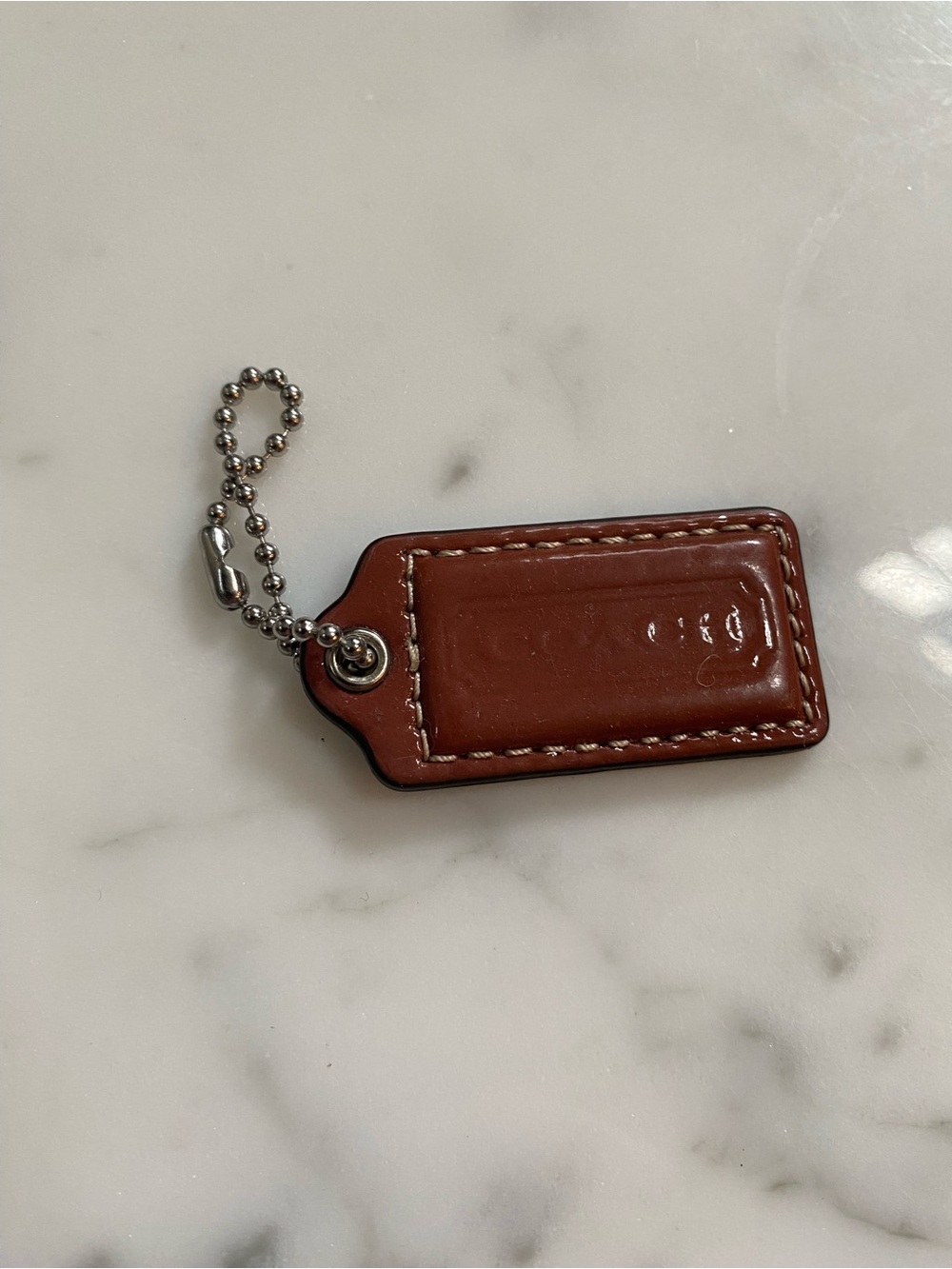Coach brown patent leather bag tag with ball chain